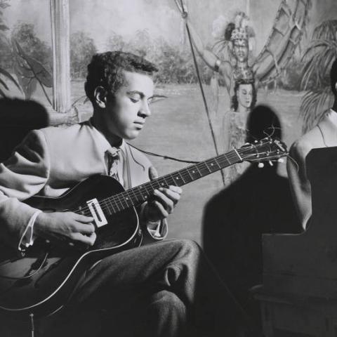 A man playing the guitar.
