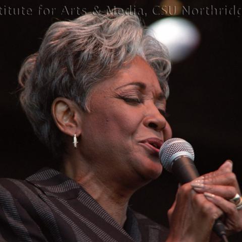 A woman singing into a microphone