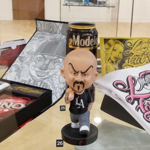 Case display with bobblehead, custom Uno deck, fliers and t-shirts.