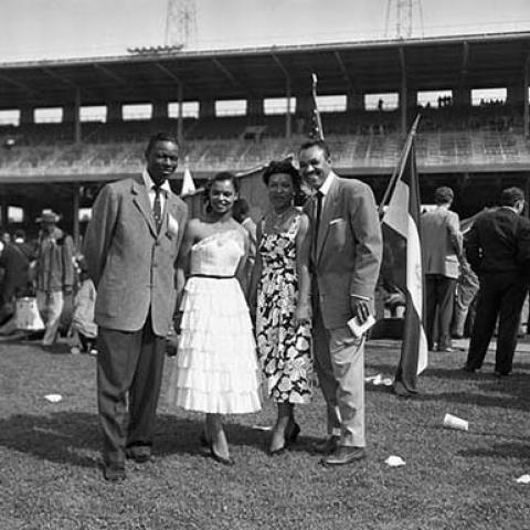 Singer Nat King Cole (left) poses with disc jockey and Master of Ceremonies, Joe Adams, and guests Clara Yaeju and Vera Forman during the 9th Annual Cavalcade of Jazz. Cavalcade of Jazz, 1953, Charles Williams Collection, 09.CW.N45.01.48