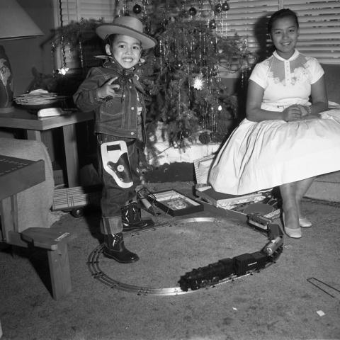 Yoshi Williams and Charles Williams IV near the Christmas tree