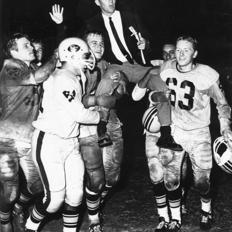 Members of the Matador football team carry Coach Sam Winningham of the field, ca. 1966. University Archives Photograph Collection
