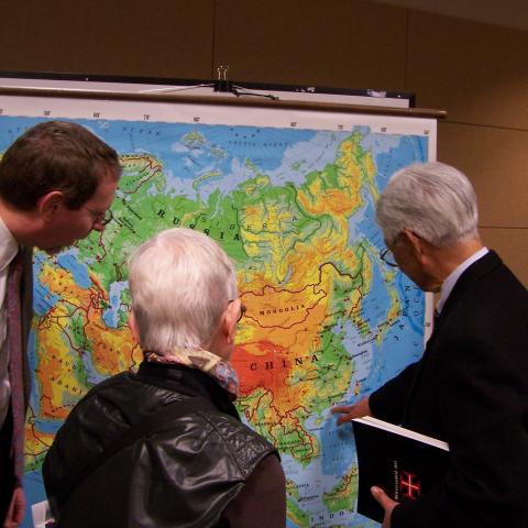 3 people looking at a map