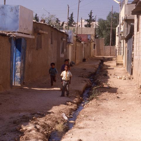 Palestinian children in the Baqa’a camp running towards and smiling for Emery’s camera. 1989. Box 6, Folder 6. 