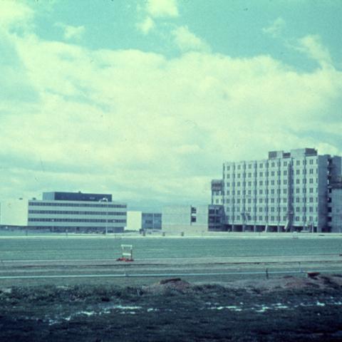 Facing south, beyond the track and field from Jacaranda Hall is what is now the University Library Lawn. In the distance to the right is the final stage of construction of the Sierra Tower with the South Library to the left. 