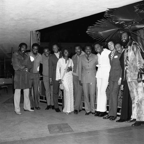 Group portrait on a patio of members of the Four Tops, the Miracles, and the Supremes, including (L to R) an unidentified man, Bobby Rogers, Levi Stubbs, Abdul "Duke" Fakir, Mary Wilson, Lawrence Payton, Warren "Pete" Moore, Renaldo "Obie" Benson, Smokey Robinson, Ronald White, and an unidentified man. Guy Crowder Collection