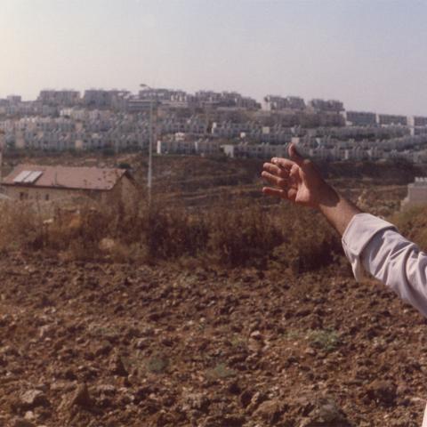 Emery tours al-Jib, a Palestinian village, with guide, Ahmed. Ahmed points out Israeli settlements on lands in the distance. ca. 1988-1991. Box 1, Folder 11. 