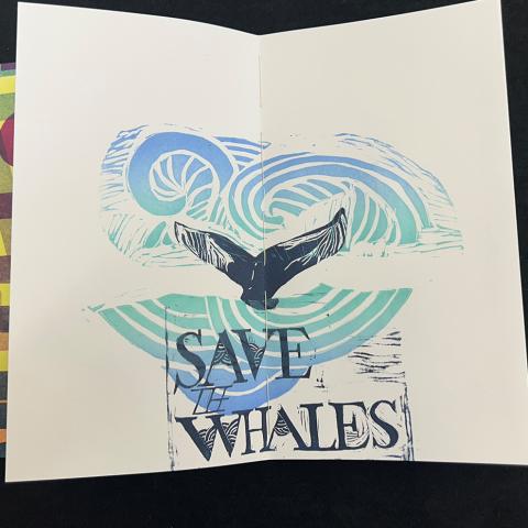 illustrated print of a whale tale peeking out from the ocean; Put It In a Blender by the Spring 2019 Printmaking III: Relief class with instructor Jamie Russom, N7433.4.P88 2019