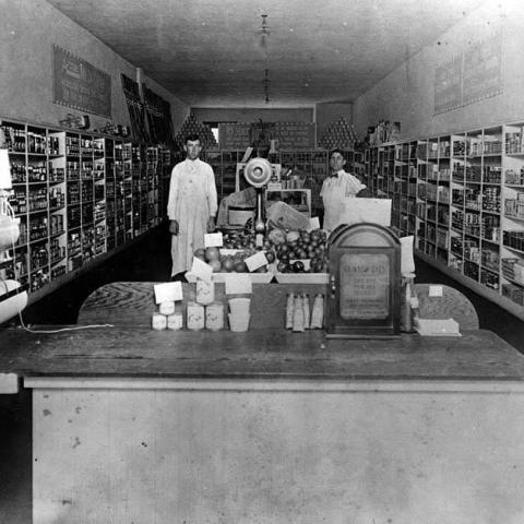 Acme Market, interior with two clerks behind the counter (F.D. Joanis, manager), ca. 1920s, ID:BHS169