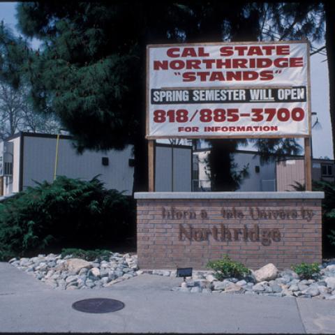 Cal State Northridge "Stands" sign, with temporary classrooms in background