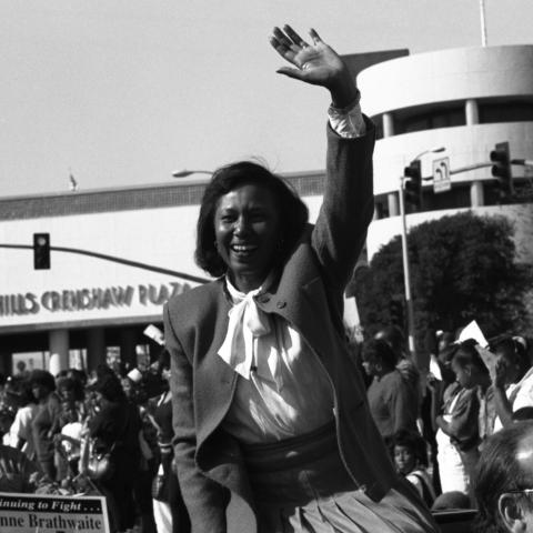 Yvonne Brathwaite Burke waving while riding a limousine convertible in front of Baldwin Hills Crenshaw Plaza during the Kingdom Day parade. In 1992, Burke would be elected to represent the second district on the L.A. County Board of Supervisors. Guy Crowder Collection, 11.06.GC.N35.B5.47.158.34A.