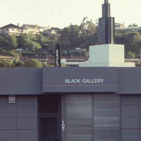 Exterior view of the Black Gallery, a gallery space specifically for black photographers to showcase their work, founded by Roland Charles in 1984 on Santa Barbara Plaza. The gallery struggled with vandalism and had its windows broken several times. The gallery closed its doors in 1998. Roland Charles Collection.