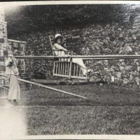 Photograph of a woman being carried in a Chinese sedan chair