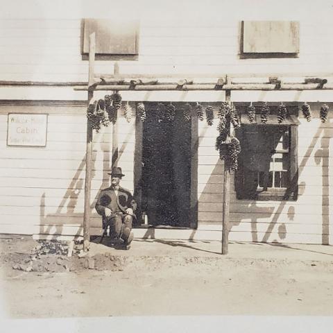 H.M. sitting in Pioneer Lodge, 1921, Johnson Family Echo Lake Photograph Collection