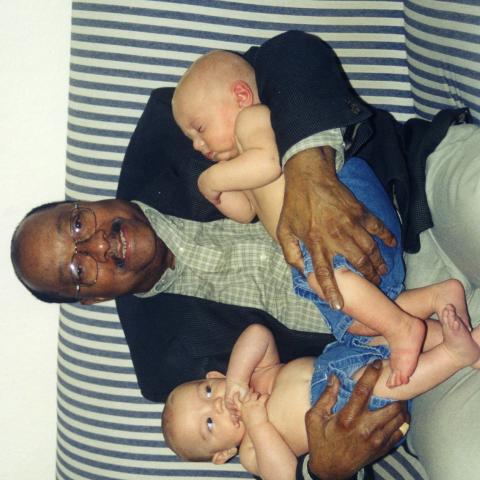 Man holding baby twins