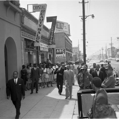 A crowd of people and motorcycle officers stand outside of Mosque No. 27, Harry Adams Photograph Collection