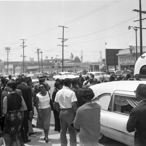 People gathered around the hearse outside Mosque No. 27 during the funeral service for Ronald Stokes, Harry Adams Photograph Collection