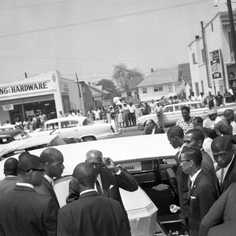 Nation of Islam pallbearers put the casket of Ronald Stokes in the hearse, Harry Adams Photograph Collection
