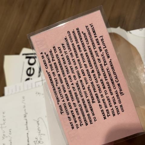 Reverse side of gay pride encouragement card included in the bag/book. N6497 .M87 2004