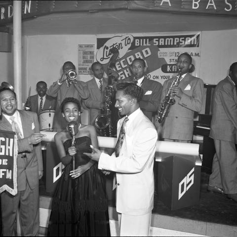 Disc Jockey Bill Sampson (left) with a band at Jack’s Basket Room nightclub. From the Charles Williams Collection.