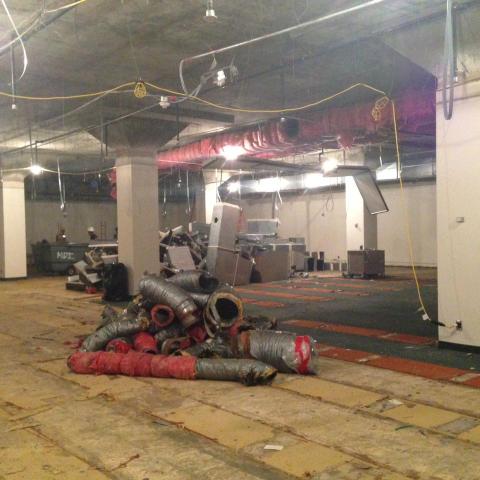 Demolition begins behind the temporary wall.