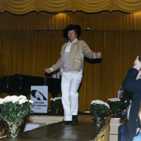 From left, Harvey and Connie Lapin are amused as a volunteer model struts down the catwalk for a photographer at a fashion show fundraiser in 1990. 
