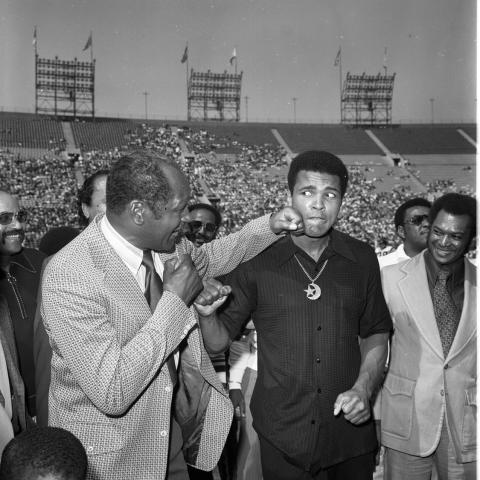 Tom Bradley throwing a playful punch at Muhammad Ali during the Freedom Football Classic, Los Angeles, 1973. Harry Adams Collection. ID: 93.01.HA.N120.B25.11.51.08