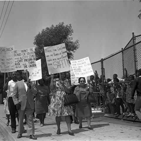 Protest for over crossing with Leon Washington (front left), Marnesba Tillmon Tackett (far right). Tackett, a civil rights activist, worked to desegregate Los Angeles public schools. 1966, Harry Adams, 93.01.HA.B1.N45.114