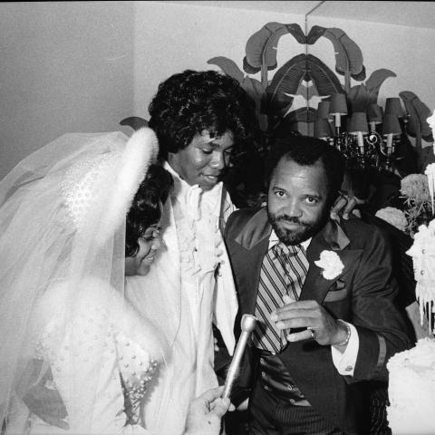 Berry Gordy prepares to speak into a microphone as his daughter Hazel and her new husband Jermaine Jackson stand near their wedding cake during the wedding reception. Guy Crowder Collection