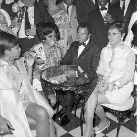 The Supremes (L-R) Mary Wilson, Diana Ross and Florence Ballard, sitting with boss, Berry Gordy, president of Motown Record Corp. Harry Adams Collection