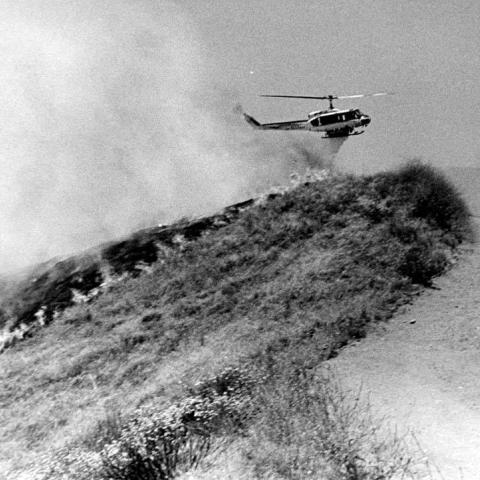Los Angeles Fire Department helicopter dropping water on a brush fire in Sylmar, 1980, Robert and Betty Franklin Collection, RBF00 025