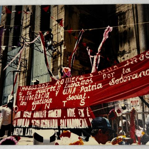 Image from collection selected by Student Assistant, Veronica: UNTS banner honors Monsenor Oscar Romero and calls for democracy, national sovereignty, and social justice hanging in front of the Metropolitan Cathedral in San Salvador, El Salvador, 1994.