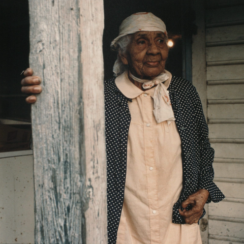 Portrait of Aunt Lulee (Beatrice White Bolden), daughter of Robert Celestin, stands on her porch. TBC.RCH