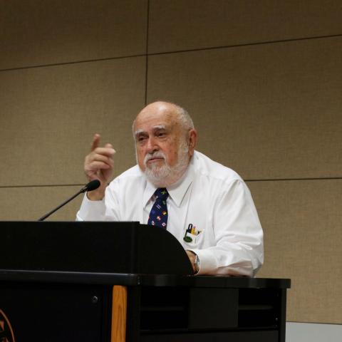 man speaking at a podium