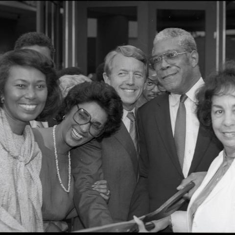 (Left to right) L.A. County Supervisor Yvonne Brathwaite Burke, Museum Director Aurelia Brooks, an unidentified man, Senator Bill Green, and Assemblywoman Teresa P. Hughes pose for a group portrait while holding a pair of giant scissors during the ribbon cutting ceremony for the California African American Museum (CAAM). 1984. Digital ID: 11.06.GC.N35.B2.17.29.07.1