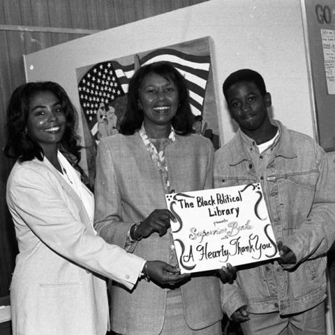 Kathleen Wiggs presenting a "Thank You" card to Yvonne Brathwaite Burke, Inglewood, California, 1992. Digital ID: 11.06.GC.N35.B6.10.28.03A