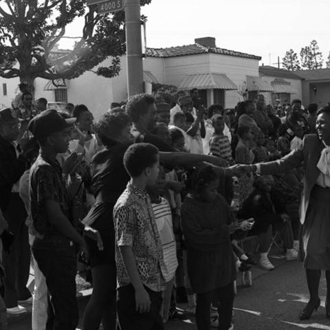 Yvonne Brathwaite Burke shaking hands with people at the Kingdom Day parade. Digital ID: 11.06.GC.N35.B5.47.159.20