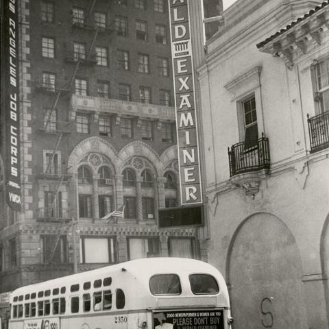 Bus passing Herald Examiner Building on 11th Street