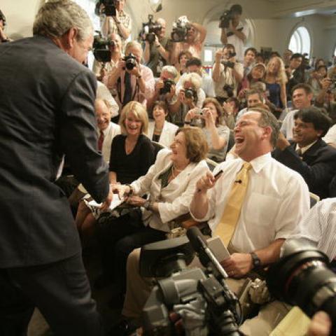 President George W. Bush conveys birthday wishes to reporter Helen Thomas in the James S. Brady Press Briefing Room