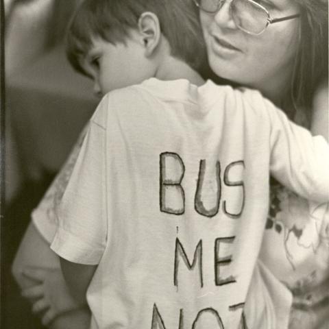 A mother holds her son at a BUSTOP campaign rally