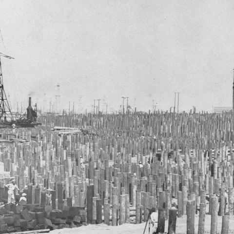 57,000 piles of lumber or stilts driven into the ground to support the shipyard