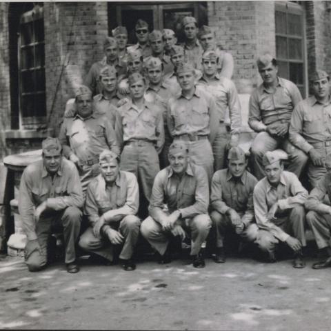 Maj. James C. Magee (front row center) poses with his battalion staff at British Embassy compound billet, Peking 1945