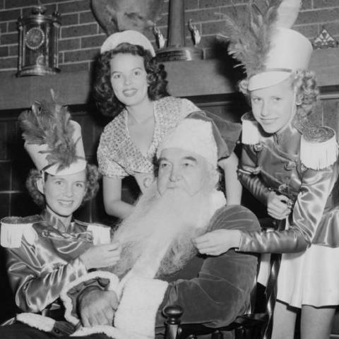 Christmas celebration with former boxing heavyweight champion of the world James (Jim) Jeffries as Santa Claus and Miss Burbank, Debbie Reynolds (on the left), 1948