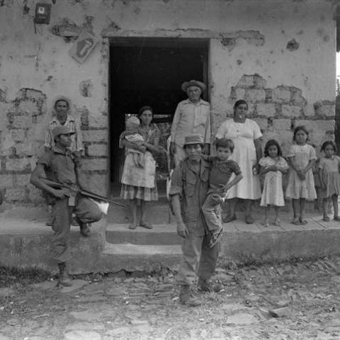 Civilians and army soldiers in front of building, Perquín, 1983