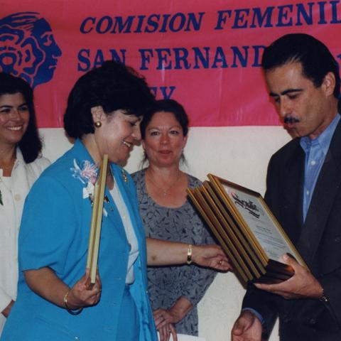 State Senator, Richard Alarcon, gives Maria Reza an award, July 1999