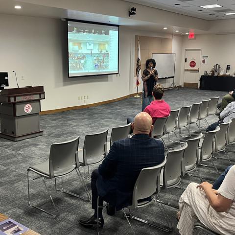 Veronica Hernandez speaking at the community event for the opening of the El Rescate Collection