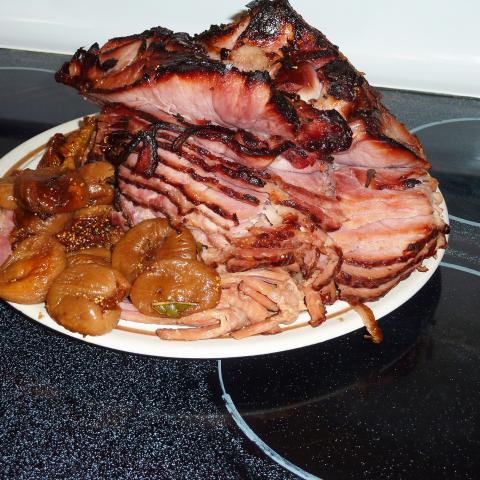 On a serving platter, the Honey Glazed Ham with figs is ready for the table. From The Horizon cookbook and illustrated history of eating and drinking through the ages, TX631 .H3 1968b v.1-2