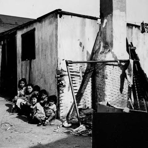 Six children sitting outside a small home at 1746 E. 41st St. in the industrial city of Vernon, five miles south of Downtown Los Angeles.
