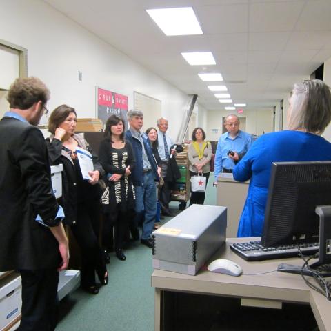 A tour group standing in front of a the kiosk being shown the automated system