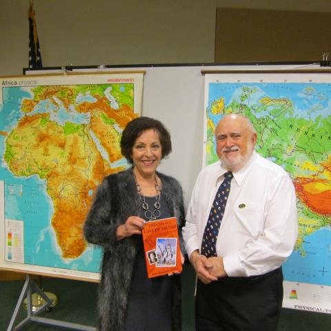 two people in front of two maps